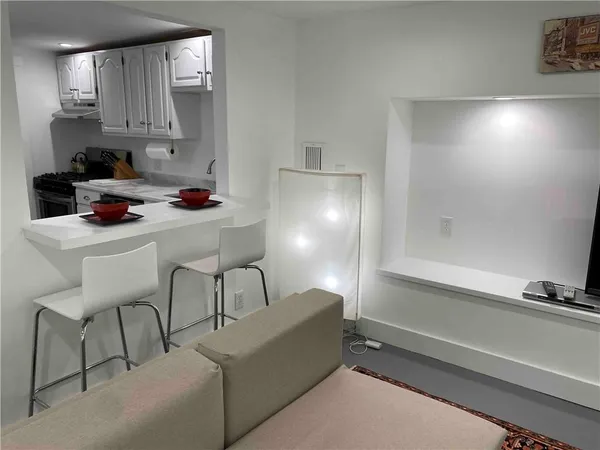 a kitchen with a sink cabinets and window
