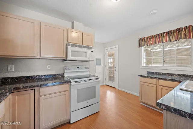 a kitchen with granite countertop a stove and a sink
