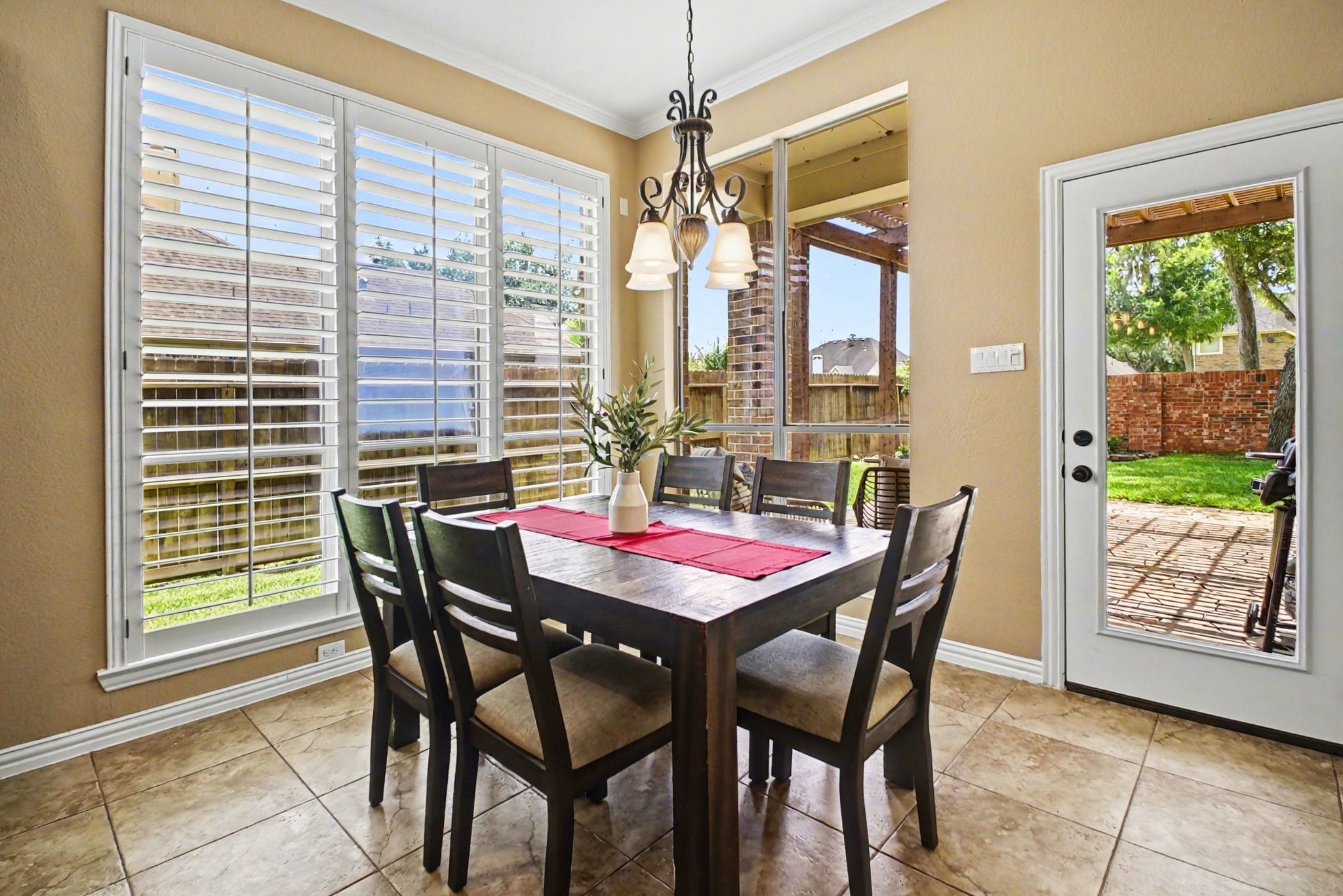 8210 Thunder Ridge Way Missouri City, TX 77459 - Photo 42 of 42 Spacious breakfast area serves as the main dining space, offering a versatile floor plan perfect for family living. Enjoy easy access to a covered patio through the glass door.