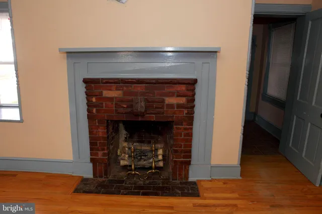 an empty room with wooden floor and a window