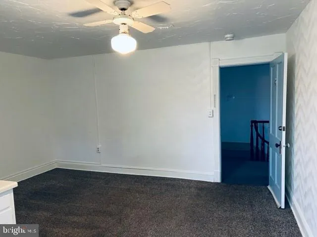 a view of a room with wooden floor and windows