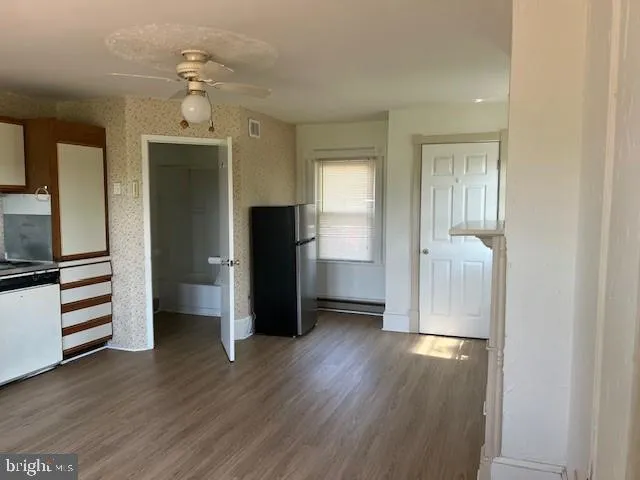 a kitchen with a refrigerator and a stove