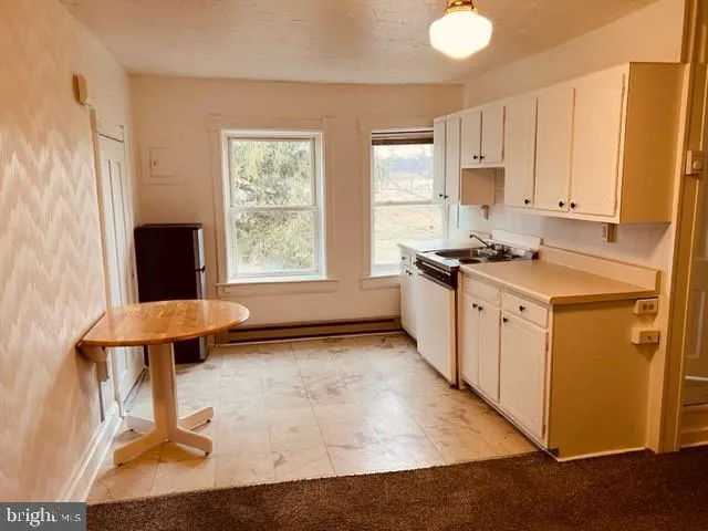 a kitchen with a refrigerator and a sink