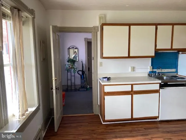 a view of a house with a big yard and large tree