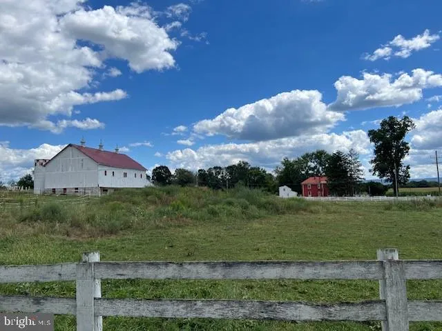 a view of a house with swimming pool next to a yard