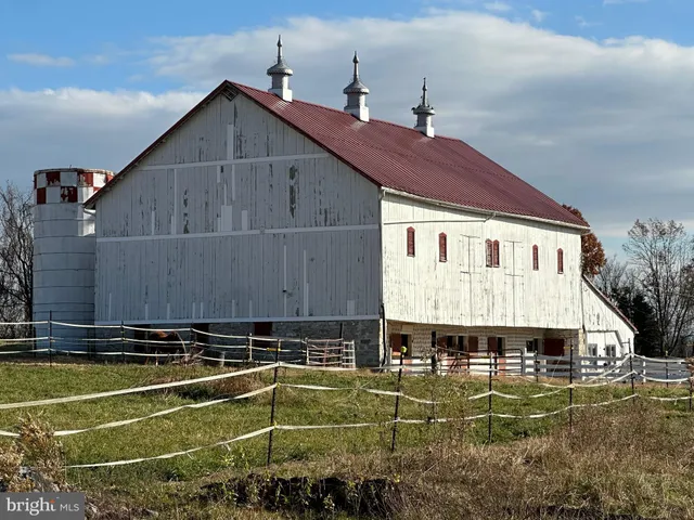 a front view of a house with a yard table and chairs