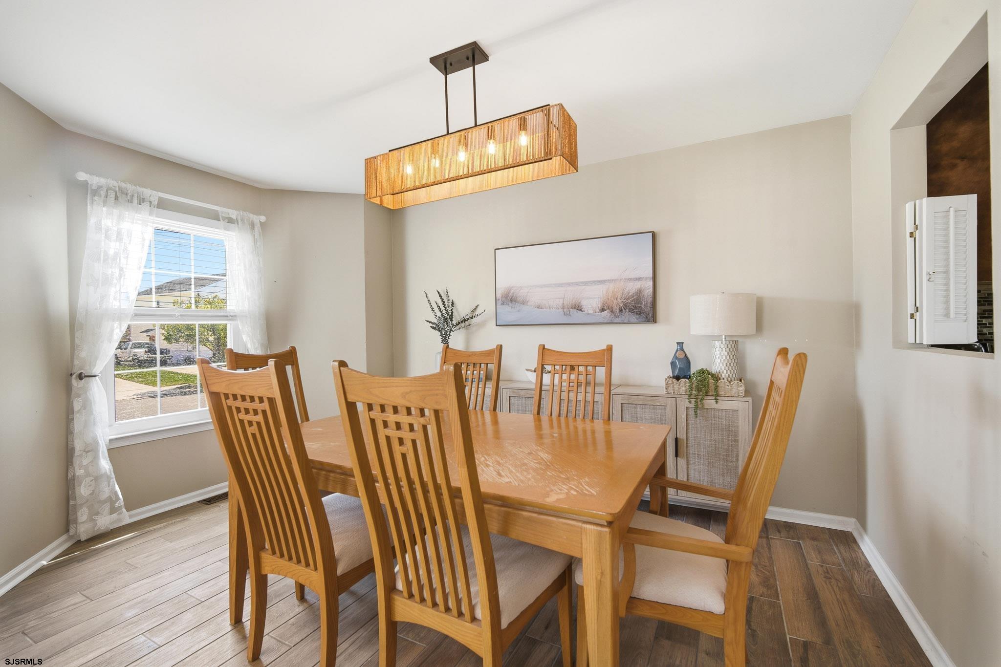 214 Hagen Road Brigantine, NJ 08203 - Photo 9 of 34 a view of a dining room with furniture and wooden floor