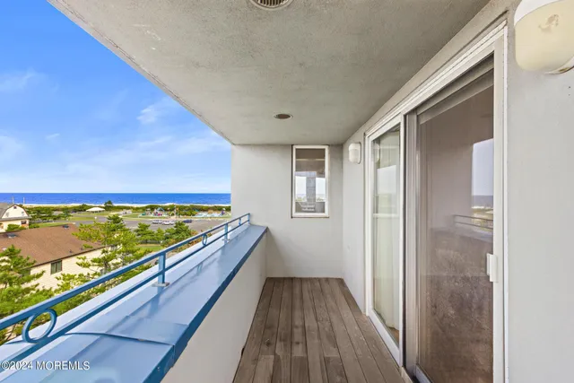 a view of hallway with wooden floor