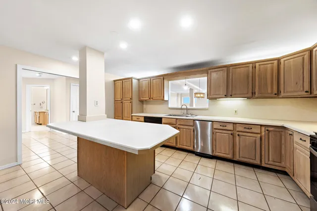 a kitchen with a sink a counter top space and cabinets