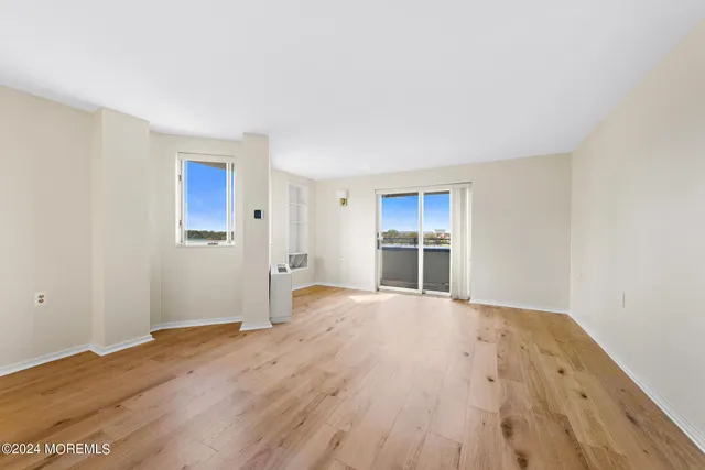 a view of wooden floor and windows in a room