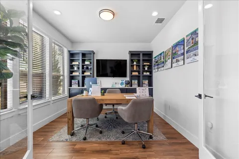 a view of a livingroom with furniture and a flat screen tv