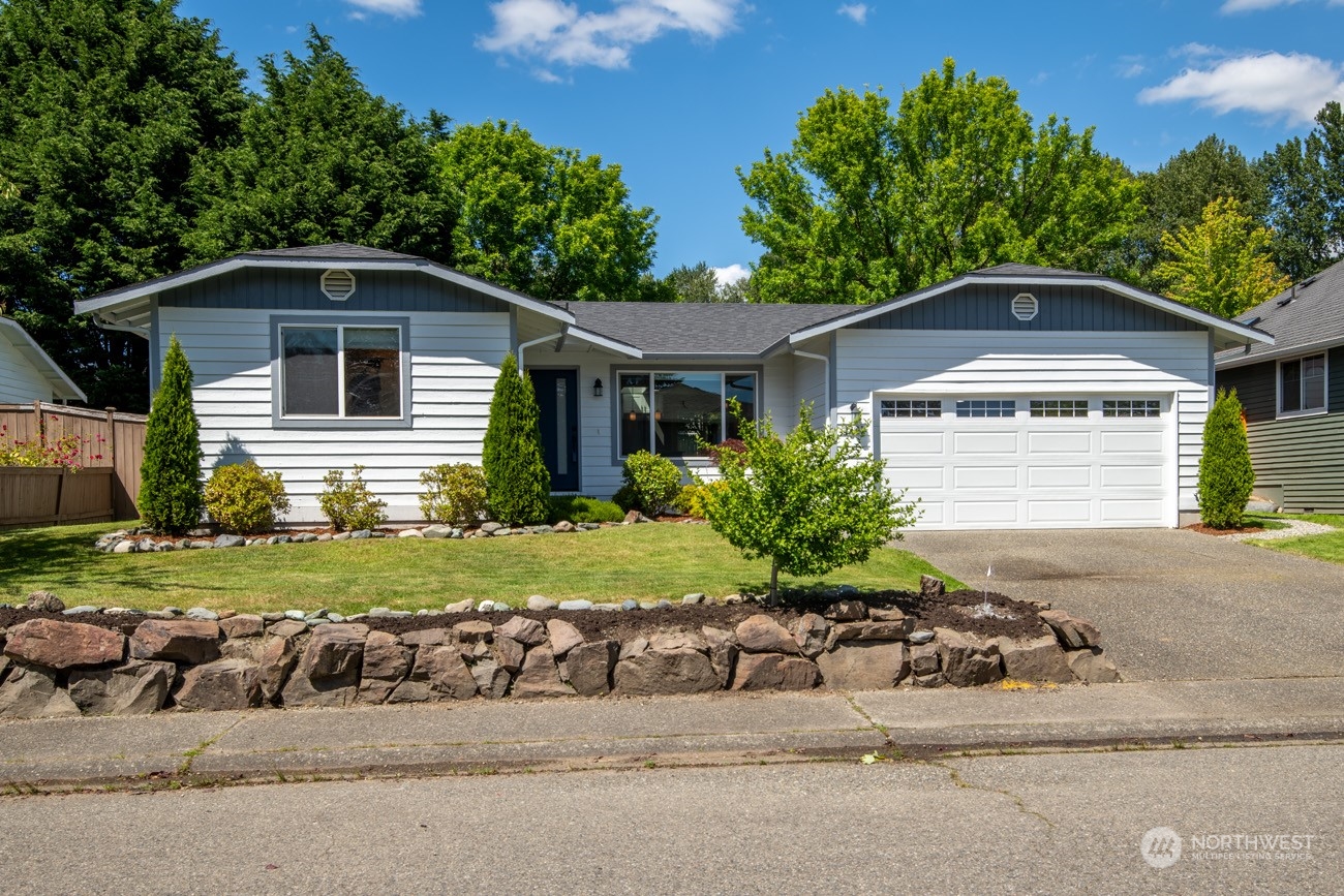 1301 234th Street Southwest Bothell, WA 98021 - Photo 1 of 21 a front view of a house with a yard