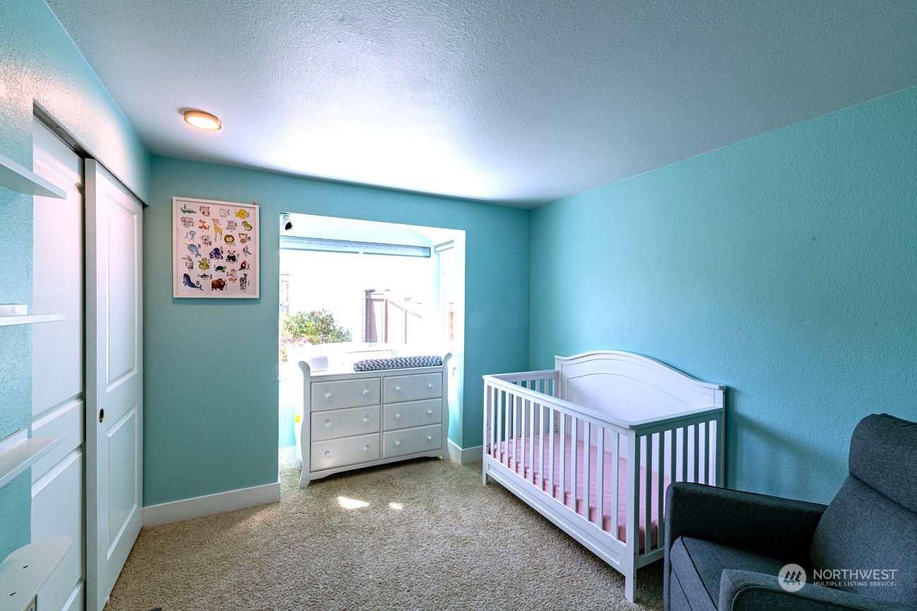 1301 234th Street Southwest Bothell, WA 98021 - Photo 11 of 21 a bedroom with a bed and a window