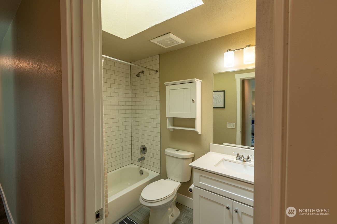 1301 234th Street Southwest Bothell, WA 98021 - Photo 13 of 21 a bathroom with a toilet a sink and shower