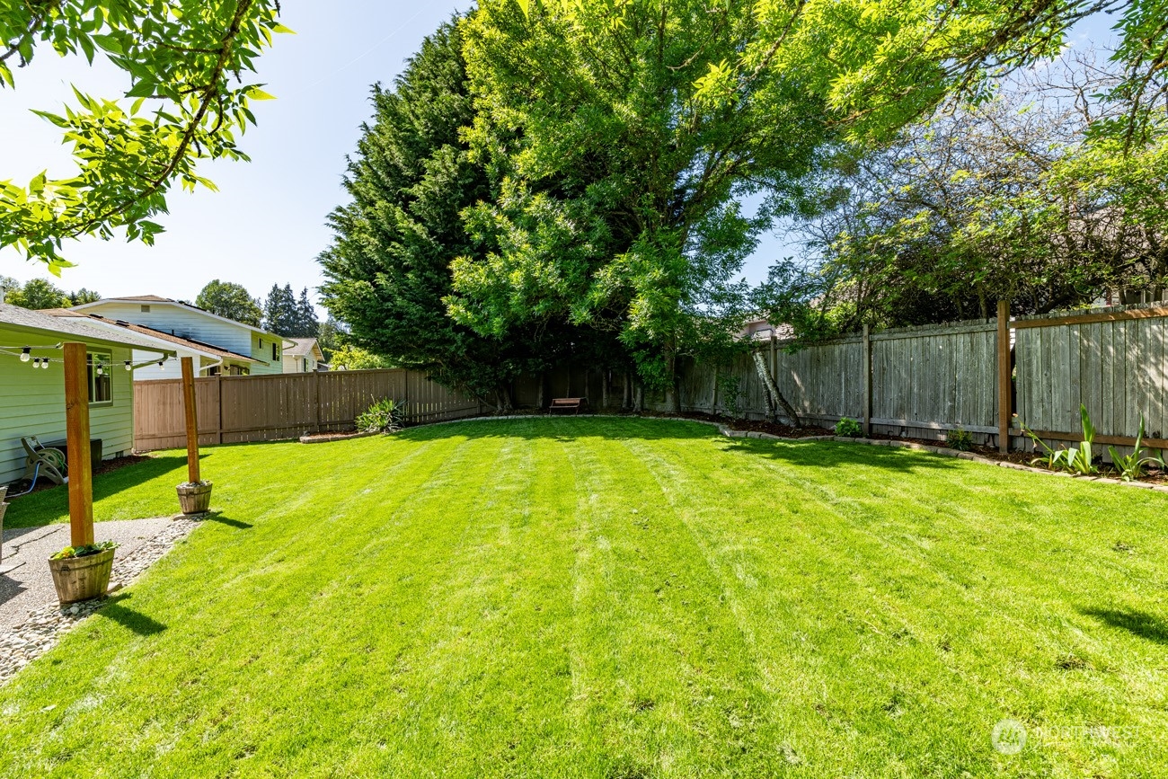 1301 234th Street Southwest Bothell, WA 98021 - Photo 16 of 21 a swimming pool with wooden fence