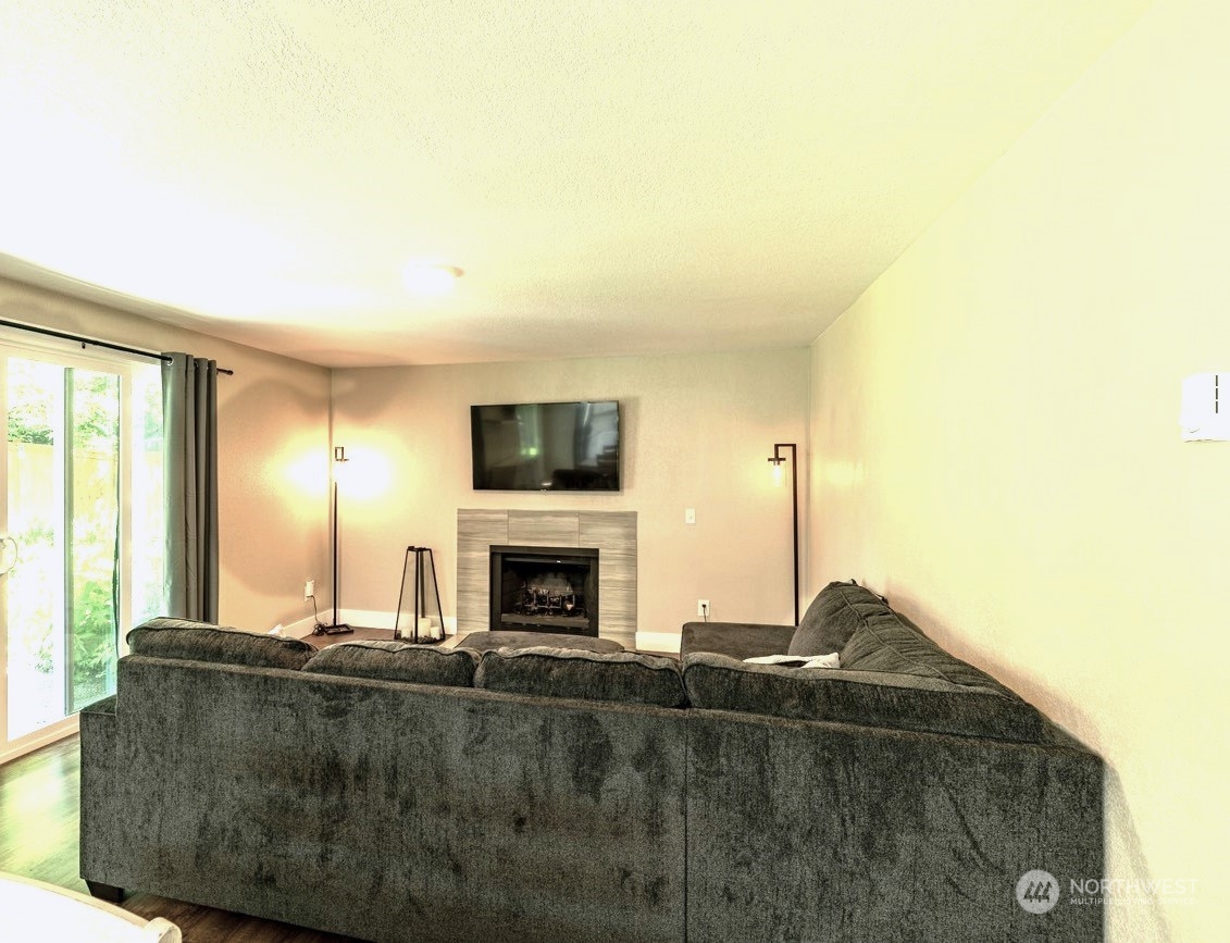1301 234th Street Southwest Bothell, WA 98021 - Photo 7 of 21 a living room with fireplace furniture and a flat screen tv