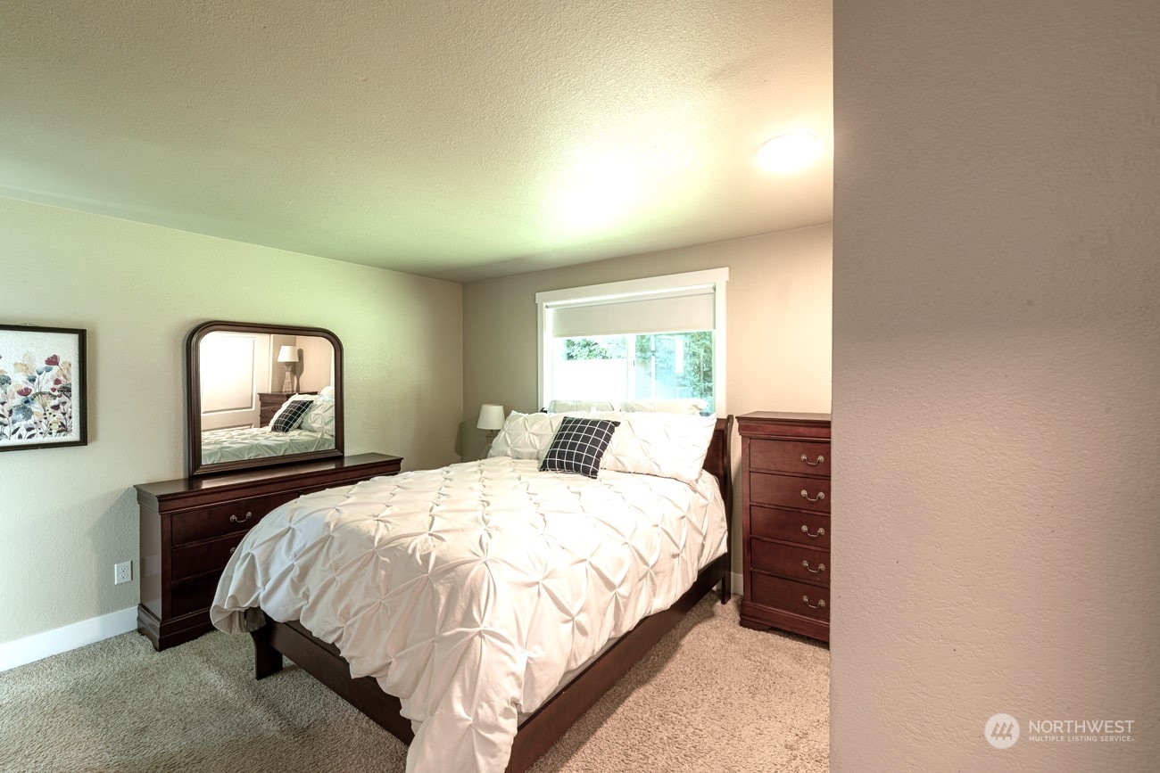 1301 234th Street Southwest Bothell, WA 98021 - Photo 9 of 21 a bedroom with a bed and window