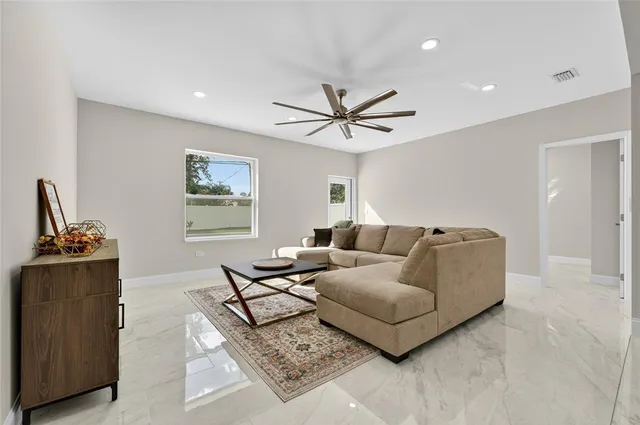 a living room with furniture and painting on the wall