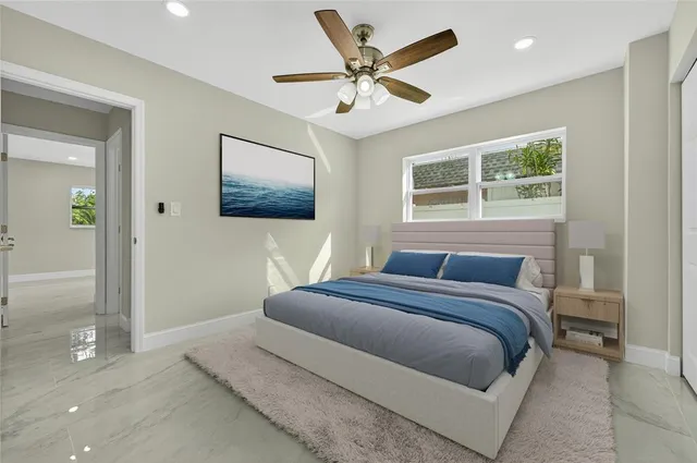 a bedroom with a large bed and a chandelier