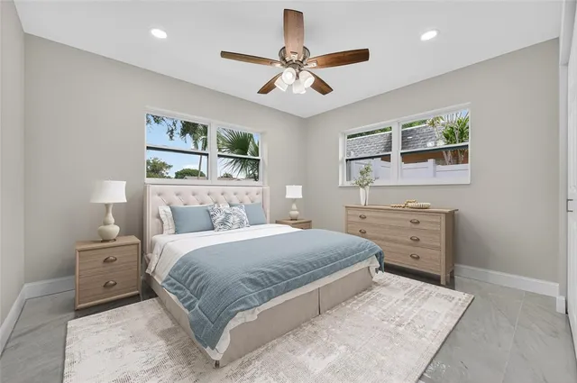 a bedroom with a large bed and a window