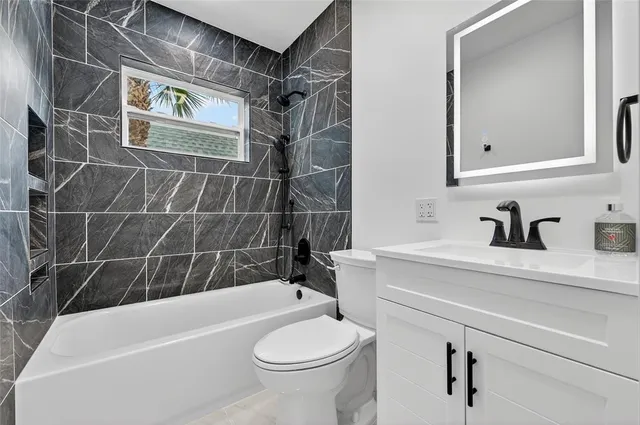 a bathroom with a sink a toilet and bathtub