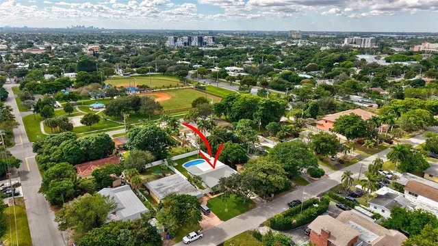 an aerial view of residential houses with outdoor space and street view