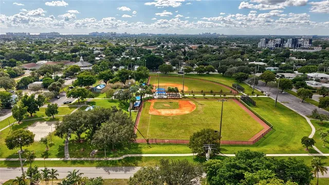 an aerial view of residential houses with swimming pool and outdoor space