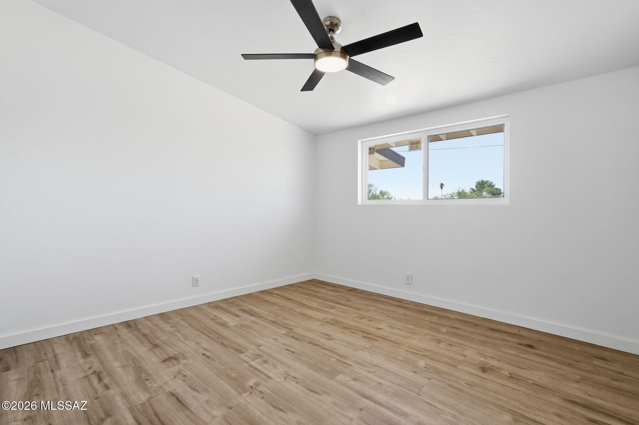 950 West Ina Road Tucson, AZ 85704 - Photo 26 of 54 an empty room with wooden floor and ceiling fan