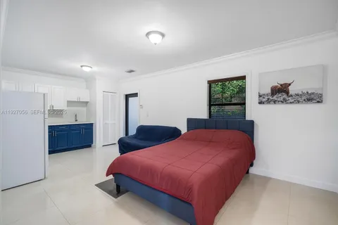 a spacious bedroom with a bed and a chair