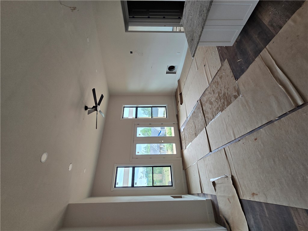 157 Hunting Hollow Road Six Mile, SC 29682 - Photo 15 of 19 An airy living area with soaring ceilings and abundant natural light from multiple windows.