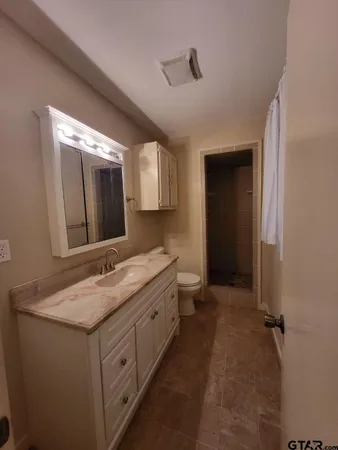 a bathroom with a granite countertop sink mirror and double