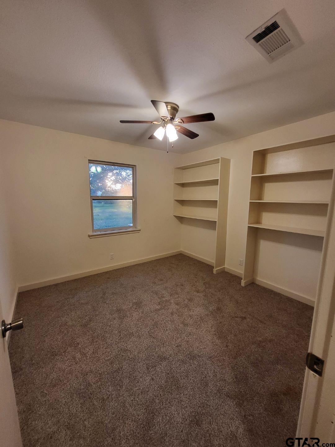 600 Cypress Street Pittsburg, TX 75686 - Photo 14 of 31 a view of a livingroom with a ceiling fan and window
