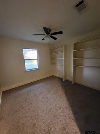 an empty room with a empty space and windows