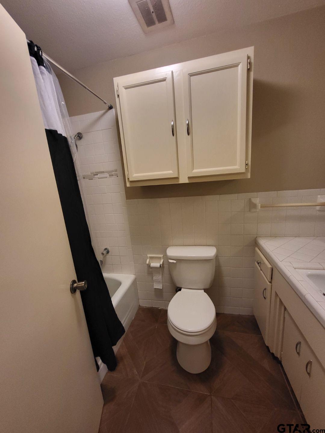 600 Cypress Street Pittsburg, TX 75686 - Photo 17 of 31 a bathroom with a toilet