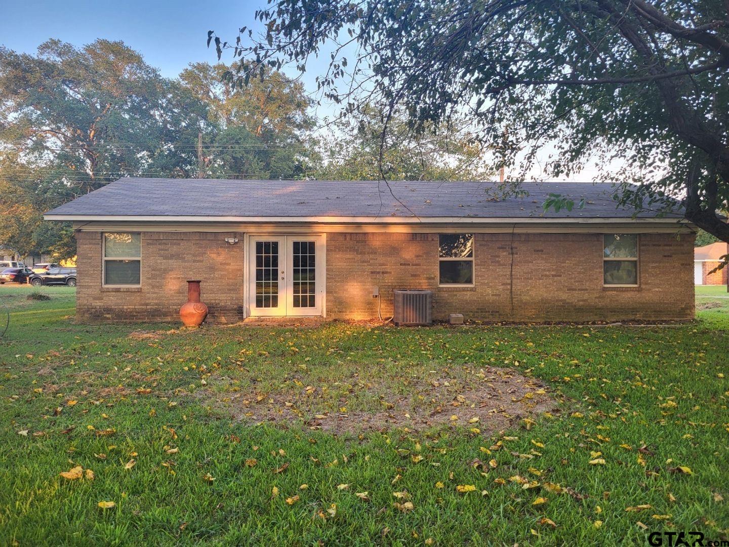 600 Cypress Street Pittsburg, TX 75686 - Photo 2 of 31 a backyard of a house with lots of green space