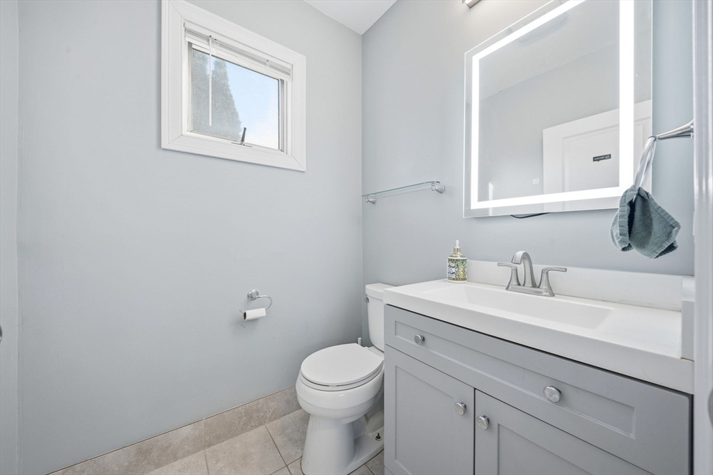 5 Main Street Quincy, MA 02169 - Photo 11 of 42 a bathroom with a toilet a sink and mirror