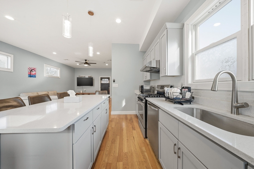 5 Main Street Quincy, MA 02169 - Photo 15 of 42 a large white kitchen with a large window
