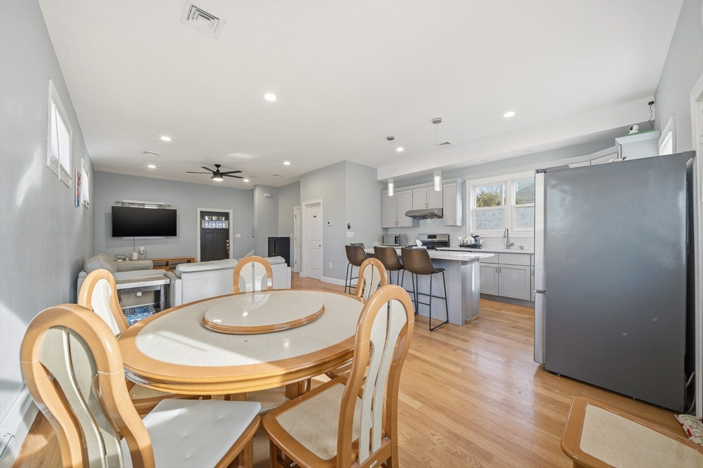 5 Main Street Quincy, MA 02169 - Photo 23 of 42 a dining room with stainless steel appliances furniture a large window and a kitchen view