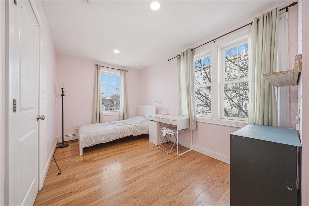 5 Main Street Quincy, MA 02169 - Photo 32 of 42 a bedroom with furniture and a wooden floor