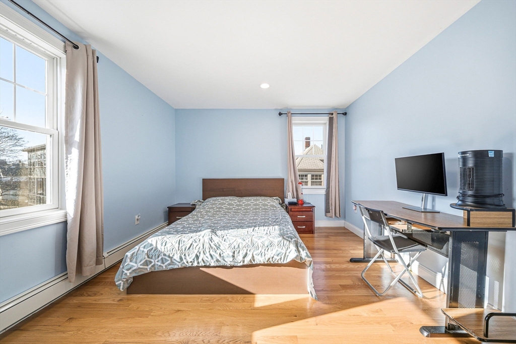 5 Main Street Quincy, MA 02169 - Photo 40 of 42 a bedroom with a bed and a flat screen tv