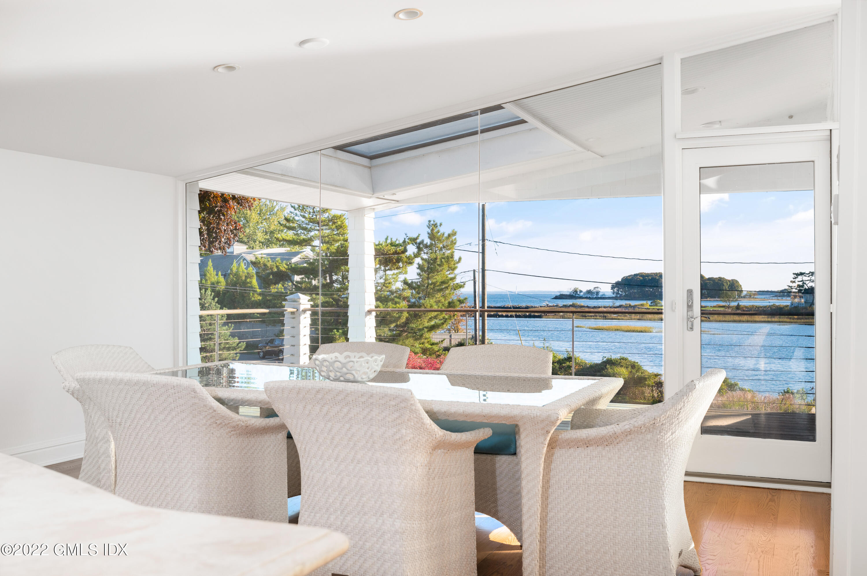 30 Surf Road Westport, CT 06880 - Photo 12 of 59 a dining room with furniture large windows and wooden floor