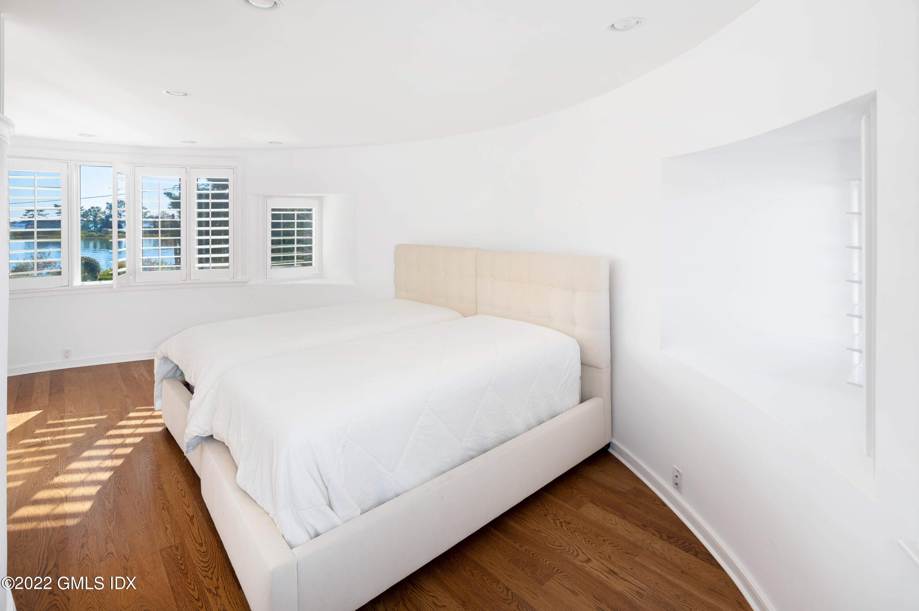 30 Surf Road Westport, CT 06880 - Photo 30 of 59 a large bed sitting in a bedroom next to a window