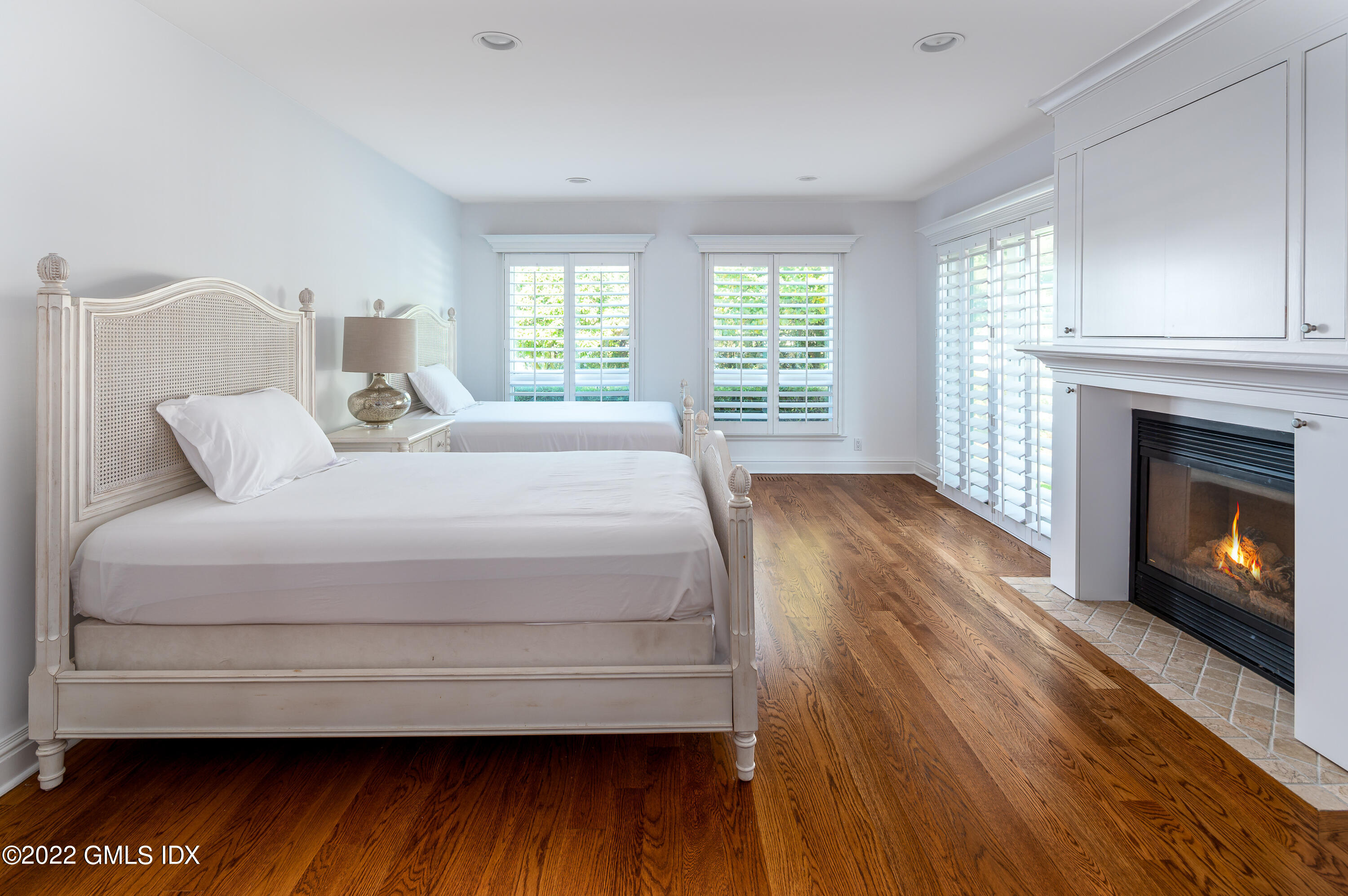 30 Surf Road Westport, CT 06880 - Photo 31 of 59 a bedroom with a bed a fireplace with a window