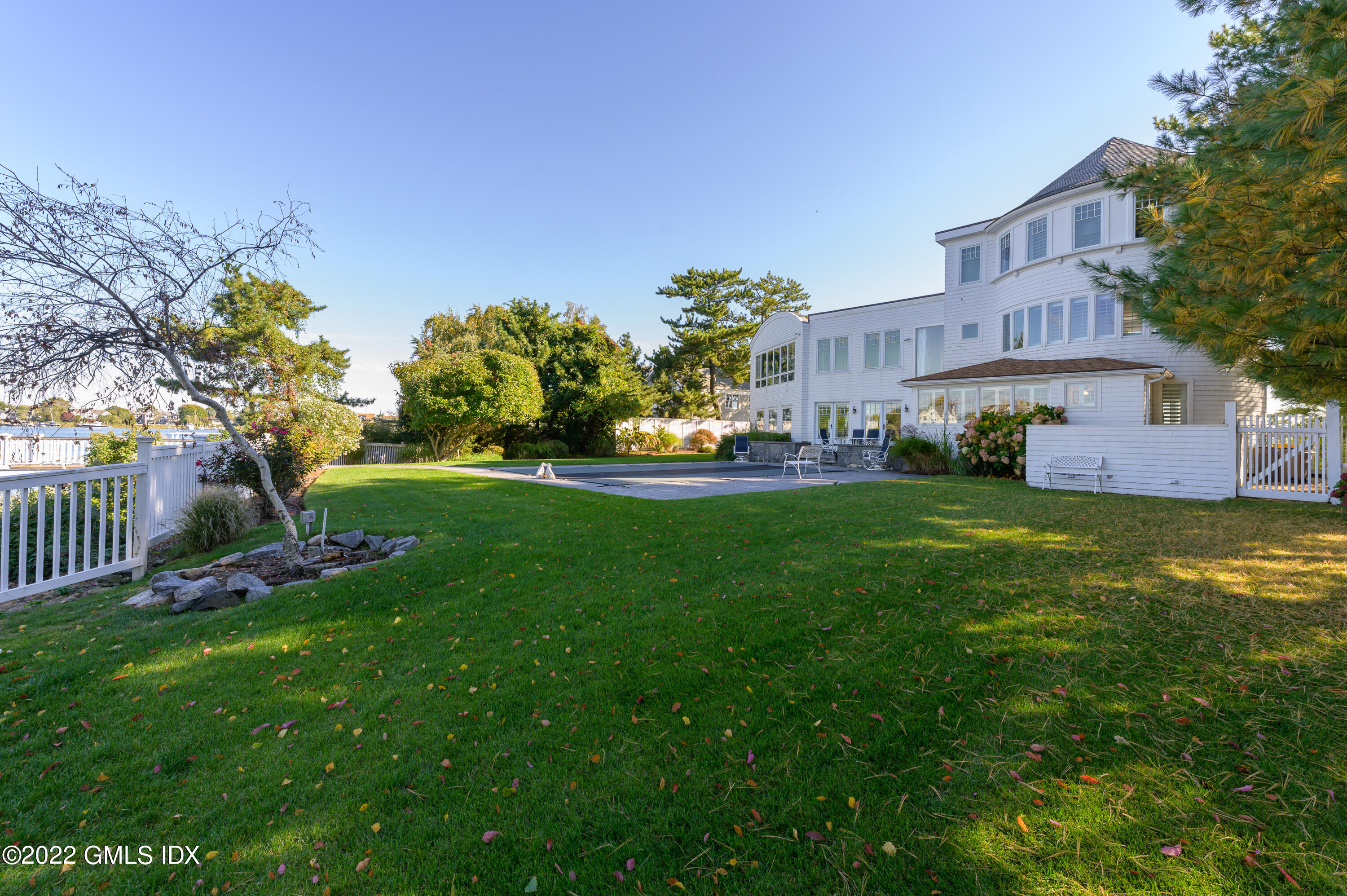 30 Surf Road Westport, CT 06880 - Photo 46 of 59 a front view of a house with a yard and outdoor seating