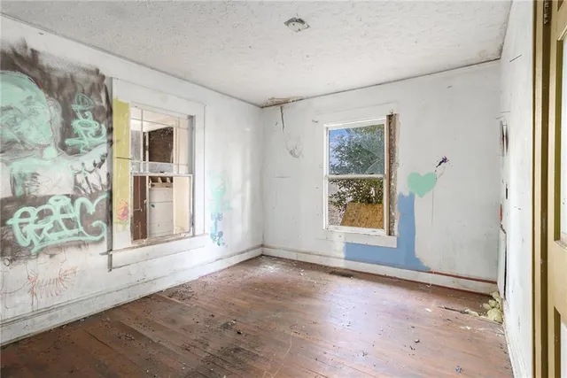 an empty room with windows and closet