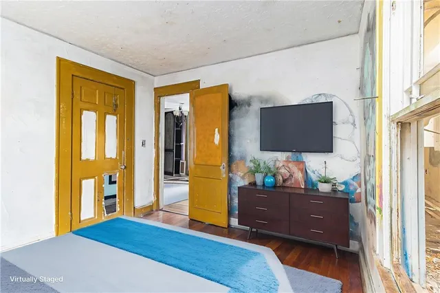 a bedroom with a bed and flat screen tv