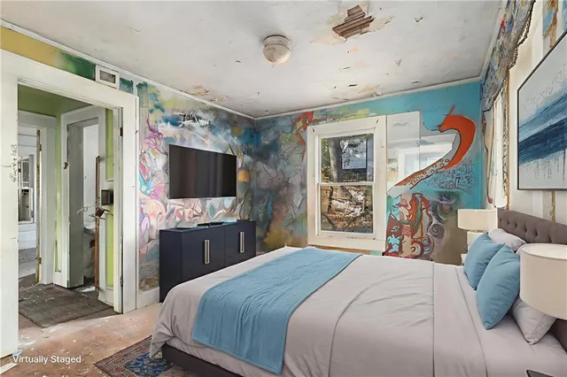 a bedroom with a large bed and a flat screen tv