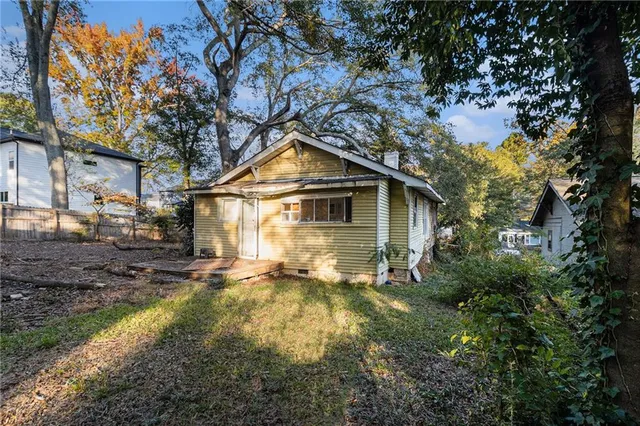 a backyard of a house with yard and outdoor seating