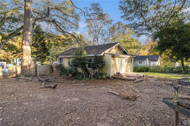 a view of a house with a yard and tree s