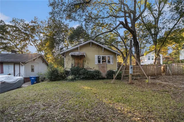 a white house that has a tree in front of it